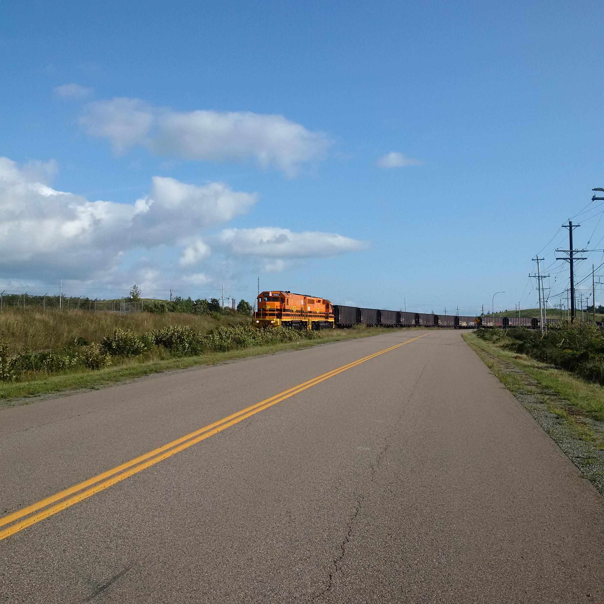 A train travelling along a road representing the Cape Breton and Central Nova Scotia Railway